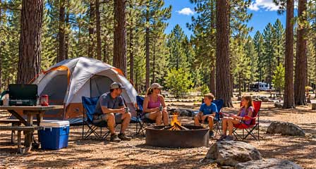 Family camping among ponderosa pine trees at Lakeside Campground near Rainbow Lake in Pinetop-Lakeside Arizona