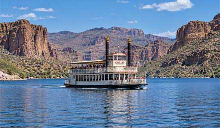 Dolly Steamboat cruising on Canyon Lake Arizona surrounded by desert canyon cliffs