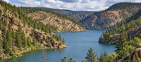 Chevelon Canyon Lake surrounded by forested canyon walls along Arizona's Mogollon Rim