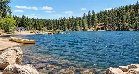 Boat launch and pine-covered shoreline at Goldwater Lake near Prescott, Arizona