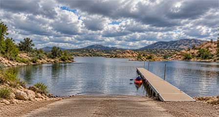 Kayaker beside the courtesy dock and boat launch at Willow Lake in Prescott Arizona
